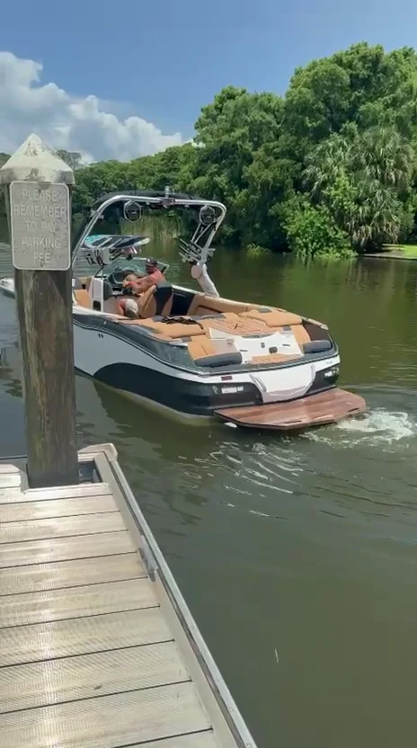 The boat pulling away from the dock