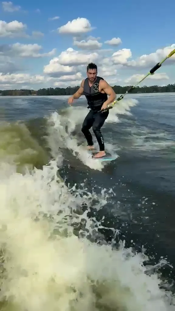 A rider wakesurfing beside the boat